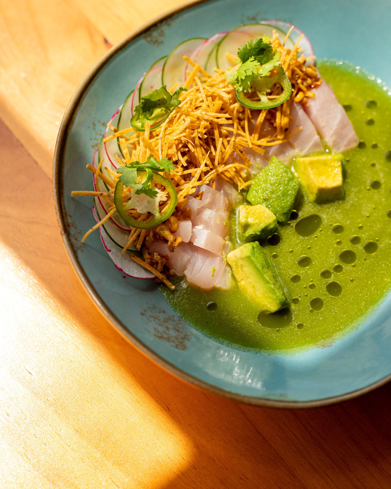 Bright, cold, and made for the heat. 🐟🌶️

Our Yellow Jack Aguachile: fresh local jack from the day's catch, avocado, roasted corn, cucumber, radish, and crispy tortilla, finished with cilantro, jalapeño and lime. The dish that cuts right through a warm island afternoon.

A house favorite, on the menu through August.

📲 Reserve your spot | Link in bio | reservations@akashabelize.com
.
.
.
#Aguachile #SeaToTableBelize #AkashaExperience